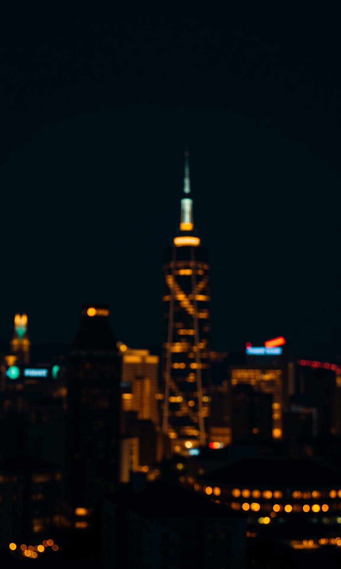 City lights at dusk across a wide skyline
